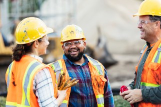 Closeup of a safety professional and workers talking on a job site