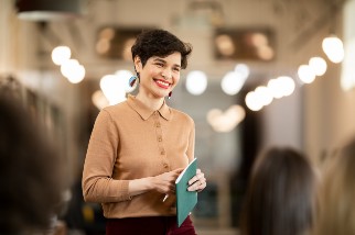 Safety professional woman holding a notebook and smiling