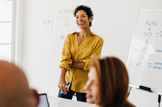 Safety professional woman smiling and giving a presentation to her team