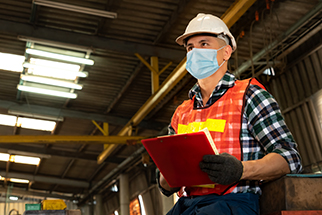 Factory worker with face mask for COVID-19