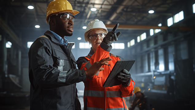 two workers discussing something at a jobsite